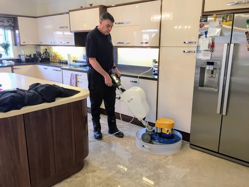 Kevin polishing a Queen beige Marble floor