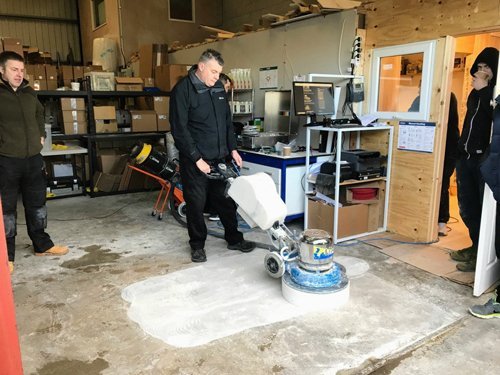 Kevin polishing a concrete floor on a course